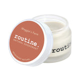 Routine Maggie's Farm deodorant - open glass jar displaying white cream texture with orange coral lid - natural ingredients visible in smooth consistency